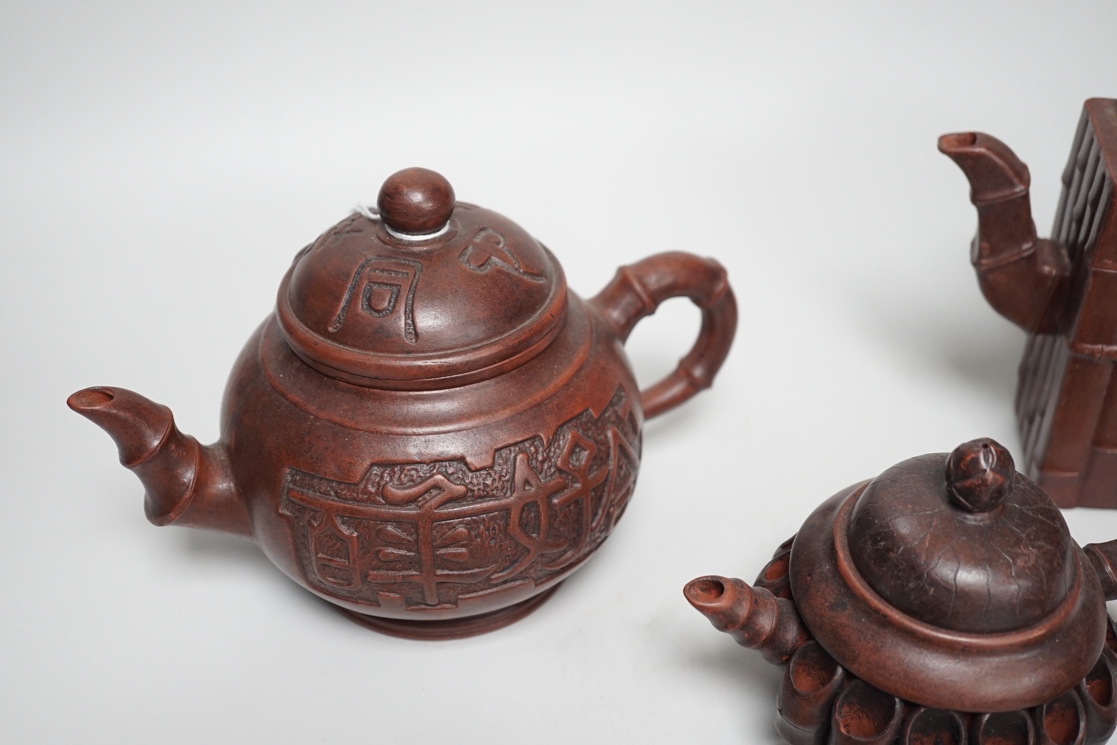 A collection of five Chinese Yixing teapots, tallest 6.5cms high